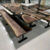 Custom black epoxy island dining table brushed steel legs detail