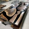 Live edge dining table with black epoxy river and matching benches