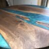 Round walnut epoxy dining table angled view