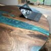 4.5ft round black walnut dining table with teal mermaid dust epoxy waves