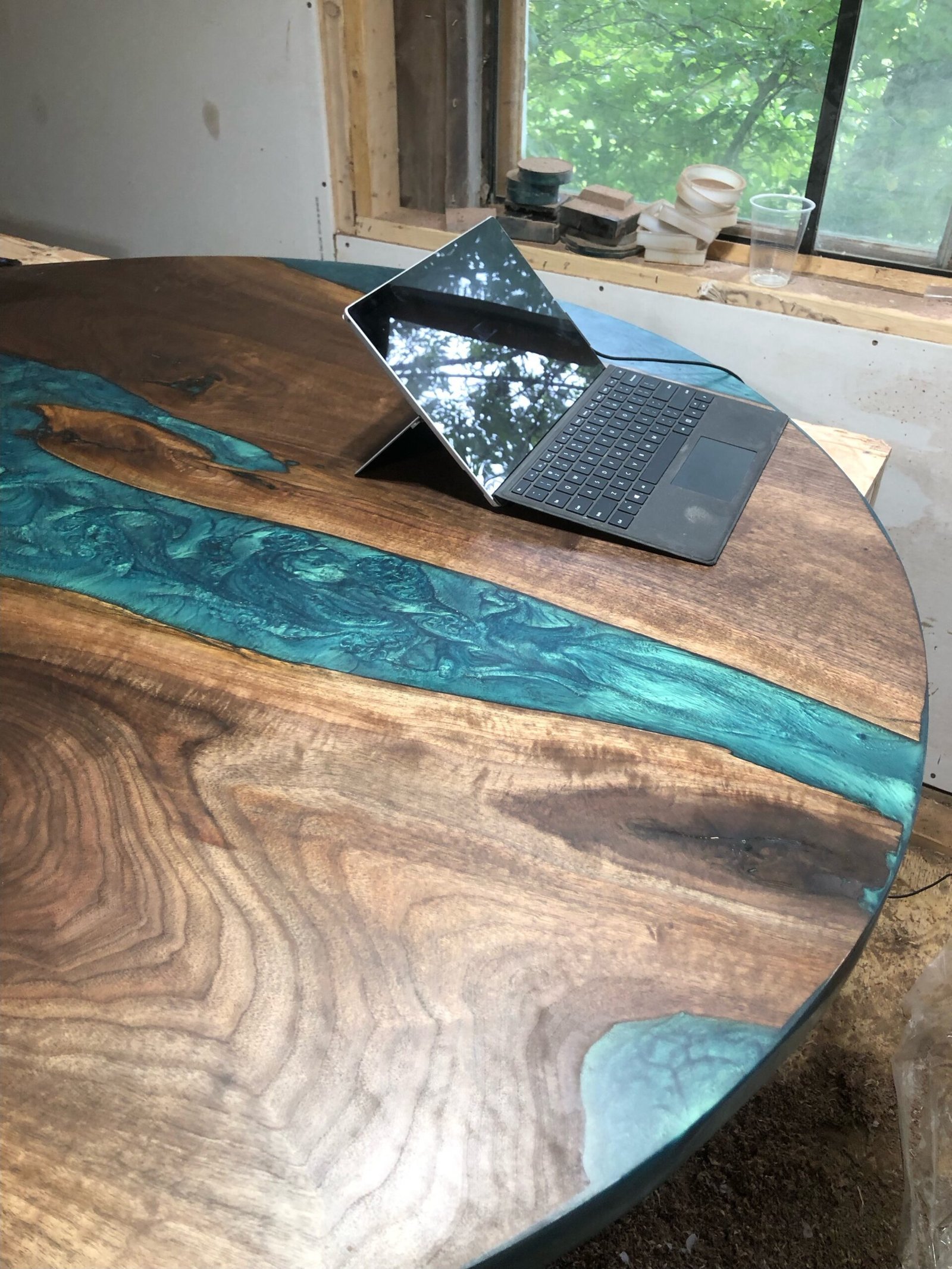 round-black-walnut-teal-epoxy-wave-dining-table-riverside-workshop 4.5ft round black walnut dining table with teal mermaid dust epoxy waves