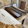 Custom black walnut office desk with clear epoxy river and natural rock features